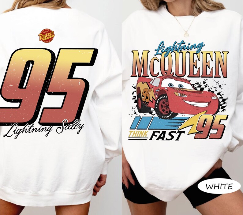 May include: White sweatshirt featuring a graphic of Lightning McQueen from the movie Cars. The front design includes the text "Lightning McQueen" and "Think Fast 95". The back displays a large "95" with "Lightning Sally" below.
