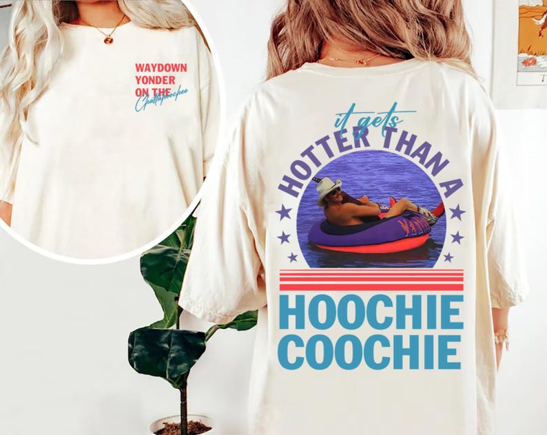 May include: Cream-colored t-shirt with the text "Waydown Yonder on the Chattahoochee" on the front. The back of the shirt features a graphic of a person in a tube on the water with the text "It gets hotter than a Hoochie Coochie".