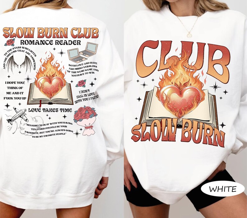 May include: White sweatshirt with a graphic design featuring the text "SLOW BURN CLUB" and "ROMANCE READER." The design includes a heart engulfed in flames above an open book. Additional text and illustrations are on the back.