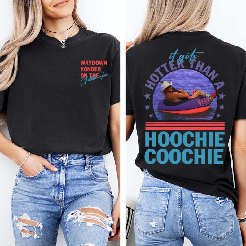May include: Black t-shirt with front and back graphics. The front reads "WAYDOWN YONDER ON THE" with a cursive signature. The back features a person in a tube with the text "it gets HOTTER THAN A HOOCHIE COOCHIE".