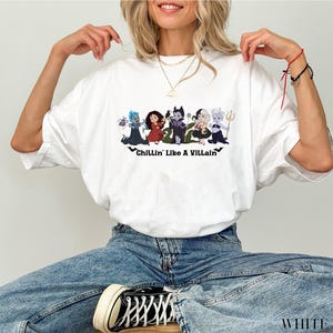 May include: A white ceramic mug with a black handle and the text "But First, Coffee" in a black, handwritten-style font. The mug is on a white surface.