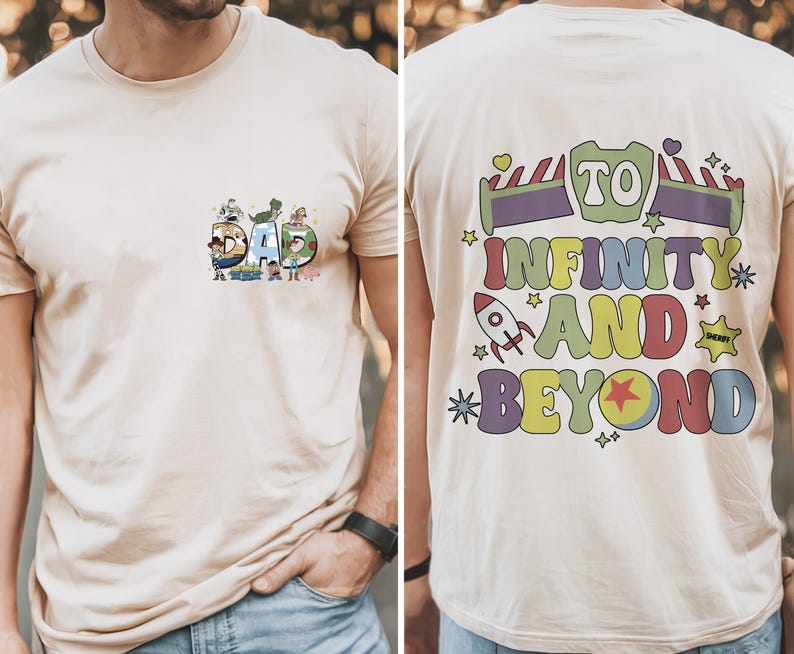 May include: Beige t-shirt with the word "DAD" in colorful letters, each letter featuring cartoon characters. The back of the shirt has the phrase "TO INFINITY AND BEYOND" in a playful, colorful design with a rocket ship and stars.