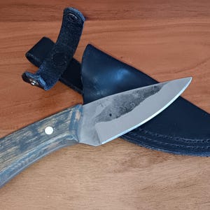 Hand forged knife with leather sheath. Brute de forge finish. Made in USA