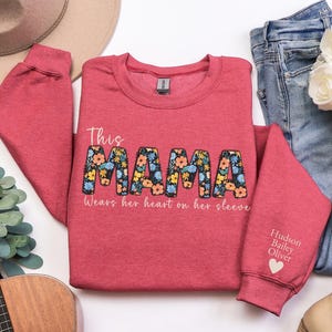 Custom This Mama Wears Her Heart On Her Sleeve Hoodie, Personalized Mom Sweatshirt With Kids Names, Cute Momma Outfit, Mothers Day Gifts