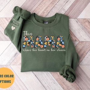 Custom This Mama Wears Her Heart On Her Sleeve Hoodie, Personalized Mom Sweatshirt With Kids Names, Cute Momma Outfit, Mothers Day Gifts