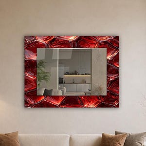 May include: A rectangular wall mirror featuring a wide, decorative frame with a glossy, deep red, three-dimensional liquid-like texture. The central reflective glass surface provides a clear view of an interior space, including a kitchen area.