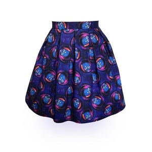 May include: A blue and purple pleated skirt with a repeating pattern of blue police boxes in a swirling galaxy design.