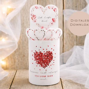 May include: A white cylindrical decorative item with a heart design made of red hearts. The item has a heart-shaped top with floral accents and the words "Ich liebe dich" and "forever and always" in red. The item is labeled "DIGITALER DOWNLOAD".