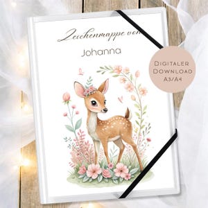 May include: A white binder with a watercolor illustration of a fawn surrounded by pink flowers and greenery. The text "Zeichenmappe von Johanna" is at the top, and a circular label reads "DIGITALER DOWNLOAD A3/A4". A black elastic band secures the binder.