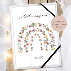 May include: White art portfolio with a floral rainbow design in pink, orange, and yellow. The text "Zeichenmappe von" is at the top, and "Louisa" is at the bottom. A black elastic band secures the portfolio.