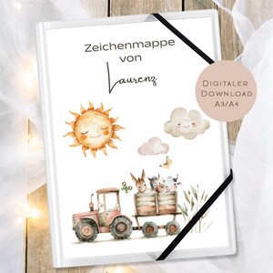 May include: White binder with a watercolor illustration of a smiling sun, clouds, and a tractor carrying animals. The text "Zeichenmappe von Laurenz" is at the top. A digital download is available.