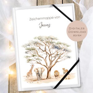 May include: A white art portfolio with a black elastic band closure. The cover features a watercolor illustration of an African savanna scene with a giraffe, elephant, lion, and cheetah under a large tree. Text on the cover reads "Zeichenmappe von Jonas."
