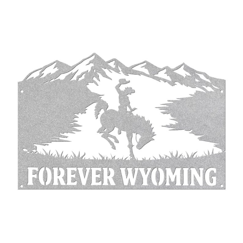 May include: A silver-colored metal wall sign featuring a cutout silhouette of a bucking horse and rider against a mountain range backdrop. The text FOREVER WYOMING is cut out at the bottom. The piece has small circular holes on the left and right sides.