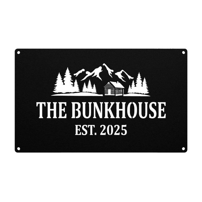 May include: Black metal sign with white text and a mountain and cabin design. The text reads "THE BUNKHOUSE EST. 2025". The sign has a rectangular shape with rounded corners and small holes in each corner for hanging.