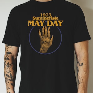 May include: Black t-shirt with a gold graphic of a hand with long claws and the text "1973 Summerisle MAY-DAY"