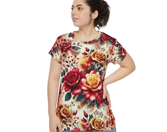 May include: A short-sleeved, cream-colored t-shirt with a floral print featuring red, yellow, and green roses.