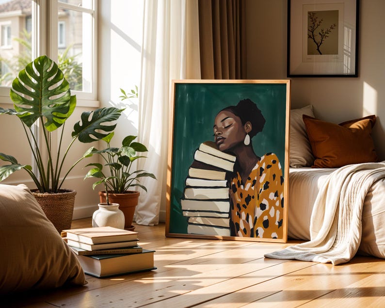 May include: A framed art print featuring a woman with her eyes closed, leaning against a stack of books. The woman wears a yellow and black patterned top and large white earrings. The artwork is set against a green background and framed in wood.