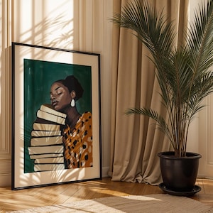 May include: Framed art print featuring a woman with closed eyes, resting against a stack of books. The artwork has a dark green background and the woman is wearing a patterned orange and black top. The print is in a black frame.