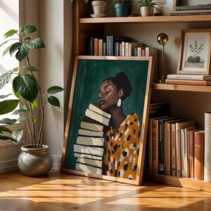 May include: A framed art print featuring a woman with a stack of books, set against a green background. The woman wears a yellow and brown patterned top and large white earrings. The artwork is displayed on a wooden bookshelf with other books and decorative items.