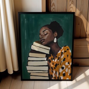 May include: A framed art print featuring a woman with dark skin resting her head on a stack of books. She wears a yellow and black patterned dress and white earrings. The background is a dark green color.