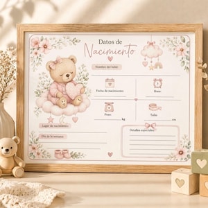 May include: A framed baby announcement board with a soft pink and beige color scheme. The design features a teddy bear holding a heart, clouds, flowers, and space to fill in baby's details. The text "Datos de Nacimiento" is at the top.