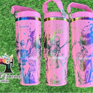 Puede incluir: Tres vasos de acero inoxidable de color rosa con asas. Los vasos est&aacute;n decorados con diferentes im&aacute;genes de la pel&iacute;cula El extra&ntilde;o mundo de Jack. Un vaso tiene el texto "Gianna" en &eacute;l.