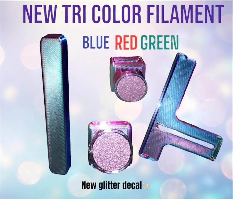 May include: A 3D printed model of the number "1/4" in blue, red, and green filament. The model is made with a glitter decal. "New Tri Colour Filament" and "Blue Red Green" are written above the model.