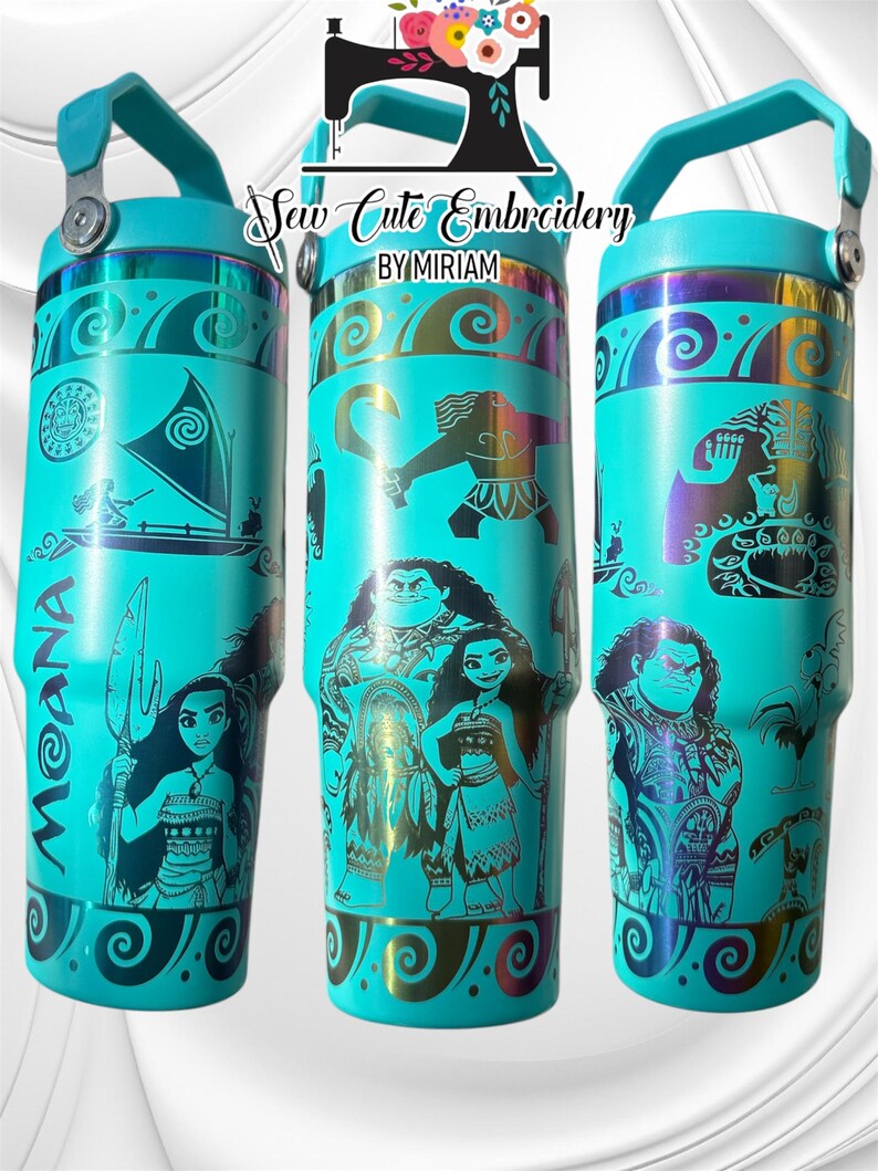 May include: Three turquoise stainless steel tumblers with a Moana theme. The tumblers feature a black and gold design with images of Moana, Maui, and the demigod Te Fiti. The tumblers have a black handle and a black lid.