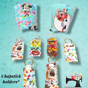 May include: Assortment of colorful fabric koozies and chapstick holders featuring various Disney characters. The koozies are designed to fit standard-sized beverage cans or bottles. The chapstick holders are designed to fit standard-sized chapstick tubes. The holders are decorated with a variety of Disney characters, including Mickey Mouse, Minnie Mouse, and Donald Duck. The text "Koozies" is displayed at the top of the image. The text "Chapstick holders*" is displayed at the bottom of the image. The text "*holder only, these do not include chapstick" is displayed at the bottom of the image. The text "Sew Cute Embroidery BY MIRIAM" is displayed at the bottom of the image.