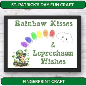 May include: A printable craft for St. Patrick's Day. The image shows a framed sign with the text "Rainbow Kisses & Leprechaun Wishes" and a rainbow made of fingerprints. A cartoon leprechaun is holding a pot of gold. The text "Fingerprint Craft" is below the frame.