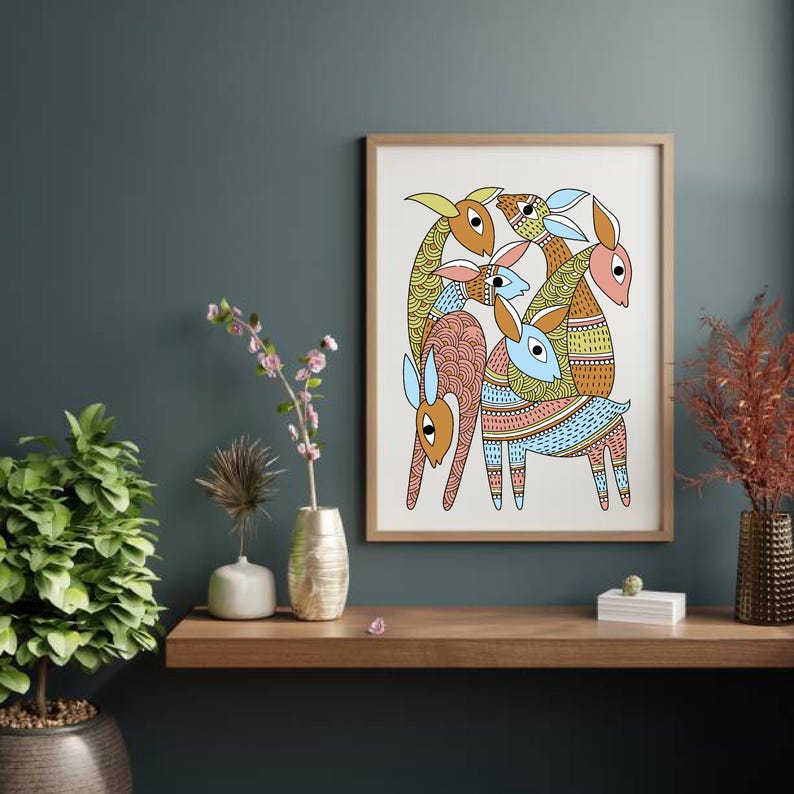 May include: A framed art print displaying a vibrant illustration of stylized animals. The artwork depicts a group of creatures with elongated necks and patterned bodies in shades of orange, blue, pink, and yellow. The print is displayed on a wooden shelf against a dark teal wall.