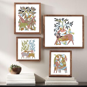 May include: Four framed art prints in a folk art style. The prints depict colourful illustrations of deer, birds, and trees in a whimsical design. The frames are made of dark wood, and the artwork is displayed on a white background.