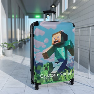 May include: Black suitcase with a Minecraft character design. The character is green and blue and is running. The suitcase has a green and blue background with clouds. The text "Custom Name" is printed on the suitcase.