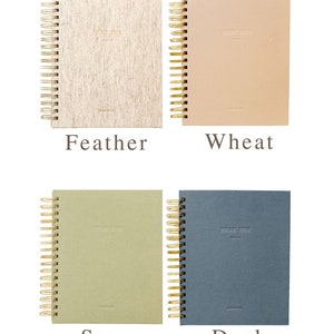 May include: Four spiral bound notebooks with different colored covers. The covers are labeled "Feather", "Wheat", "Sage", and "Dusk". Each cover has the text "Dear Him" embossed on the front.