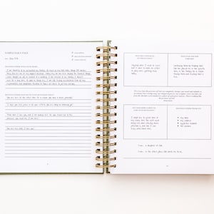 May include: A two-page spread from a green and white daily planner with a gold spiral binding. The left page has a section for "Gratitude" and "Daily Affirmations". The right page has sections for "How Will I Choose to Respond Today?" and "What is the Next Step Forward?"
