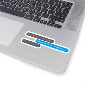 May include: A laptop with stickers that read "Bro I finally launched my startup", "Congratulations bro, send me the link", and "http://localhost:3000". The stickers are white with black and blue text. The laptop is silver.
