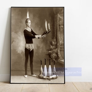 May include: A black and white vintage photograph of a man in a black and white costume juggling flaming clubs. He is standing on a stage with a backdrop of a mirror and a potted plant. The text "Perfect Photo Prints" and "Watermark Will Not Appear on Print" is visible in the bottom right corner of the image.