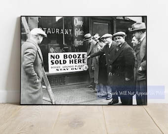 May include: Black and white photograph of a group of men in suits and hats standing outside a restaurant. A sign reads "NO BOOZE SOLD HERE." The restaurant's window displays "Chop, Cutlets, Oyster."