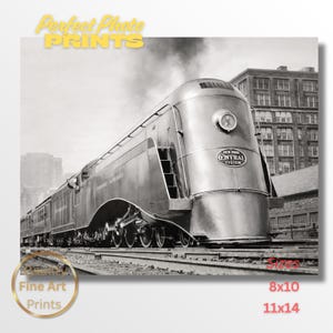 May include: Black and white photograph of a streamlined train, the New York Central System, on tracks. The train is in front of a city skyline. The image includes the text "Perfect Photo Prints" and "Fine Art Prints". Available sizes are 8x10 and 11x14.