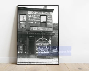 May include: Black and white photo of a storefront with the text "HUGGINS CASH CHEMIST" and "R.H.HUGGINS W. WILKINSON & SON" above the entrance. The storefront has a sign that reads "BOROUGH PHARMACY" and "HORSE & CATTLE MEDICINES".