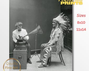 May include: Black and white photograph featuring two people and a vintage gramophone. One person is operating the gramophone, while the other is wearing a Native American headdress and traditional clothing. The image has text that says "Perfect Photo Prints" and "Quality Fine Art Prints".