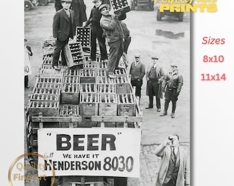 May include: Black and white vintage photograph of men loading crates of beer bottles onto a truck. A sign on the truck reads "BEER" and "HENDERSON 8030". The image is a fine art print available in 8x10 and 11x14 sizes.