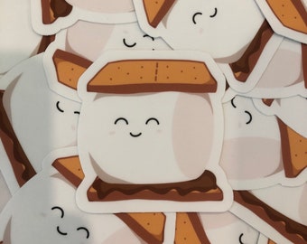 May include: A stack of brown, white, and chocolate brown s'mores stickers with a smiling marshmallow face.