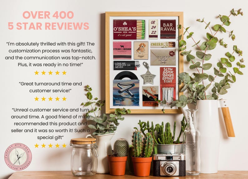 May include: A framed collage of matchboxes, a record, and other small decorative items. The matchboxes feature various designs and text, including "O'Shea's", "Bar Ravel", and "Cheers". The record is a 45 RPM record with a silver star on the cover. The collage is surrounded by a wooden frame and is displayed on a white wall with plants in front of it.