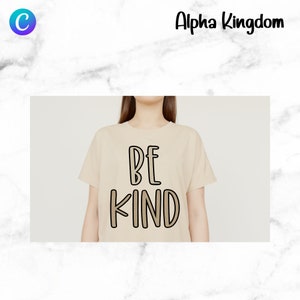 May include: A beige t-shirt with the text "BE KIND" in brown and black lettering.