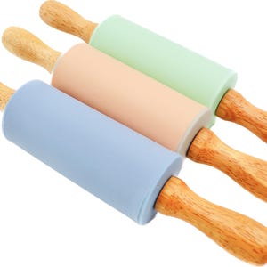 May include: Three wooden rolling pins with silicone handles. The rolling pins are light blue, peach, and light green.