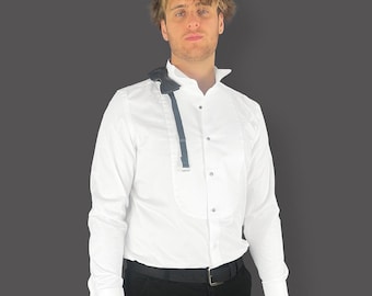May include: A white dress shirt with a black bow tie and a black belt. The shirt has a wing collar and a single button closure.