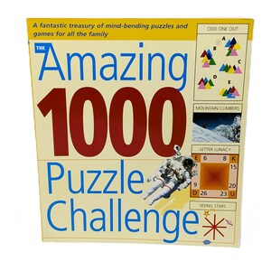 May include: A cream-coloured puzzle box labelled "The Amazing 1000 Puzzle Challenge." The box has large red numbers and blue text. It features puzzle examples, including "Odd One Out" and "Mountain Climbers," and an illustration of an astronaut.