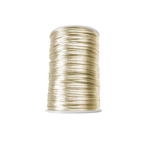 May include: A spool of cream-colored satin cord.