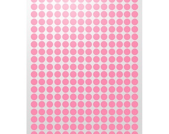 May include: A sheet of pink round stickers. The stickers are arranged in a grid pattern.